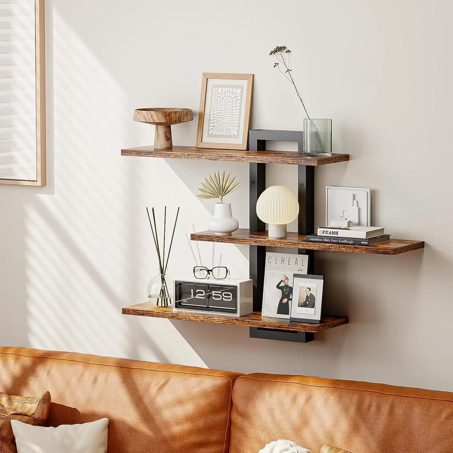 Three-tiered floating shelves with rustic wood shelves and black metal brackets for wall decor and adjustable storage