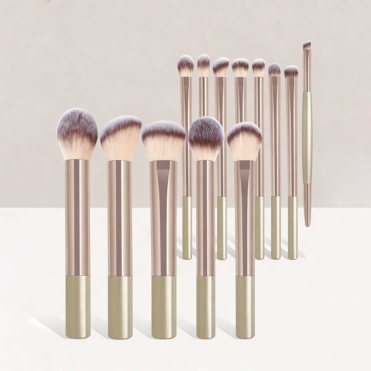 Set of 12 elegant rose gold and matte beige makeup brushes with soft dense bristles for professional cosmetic use.