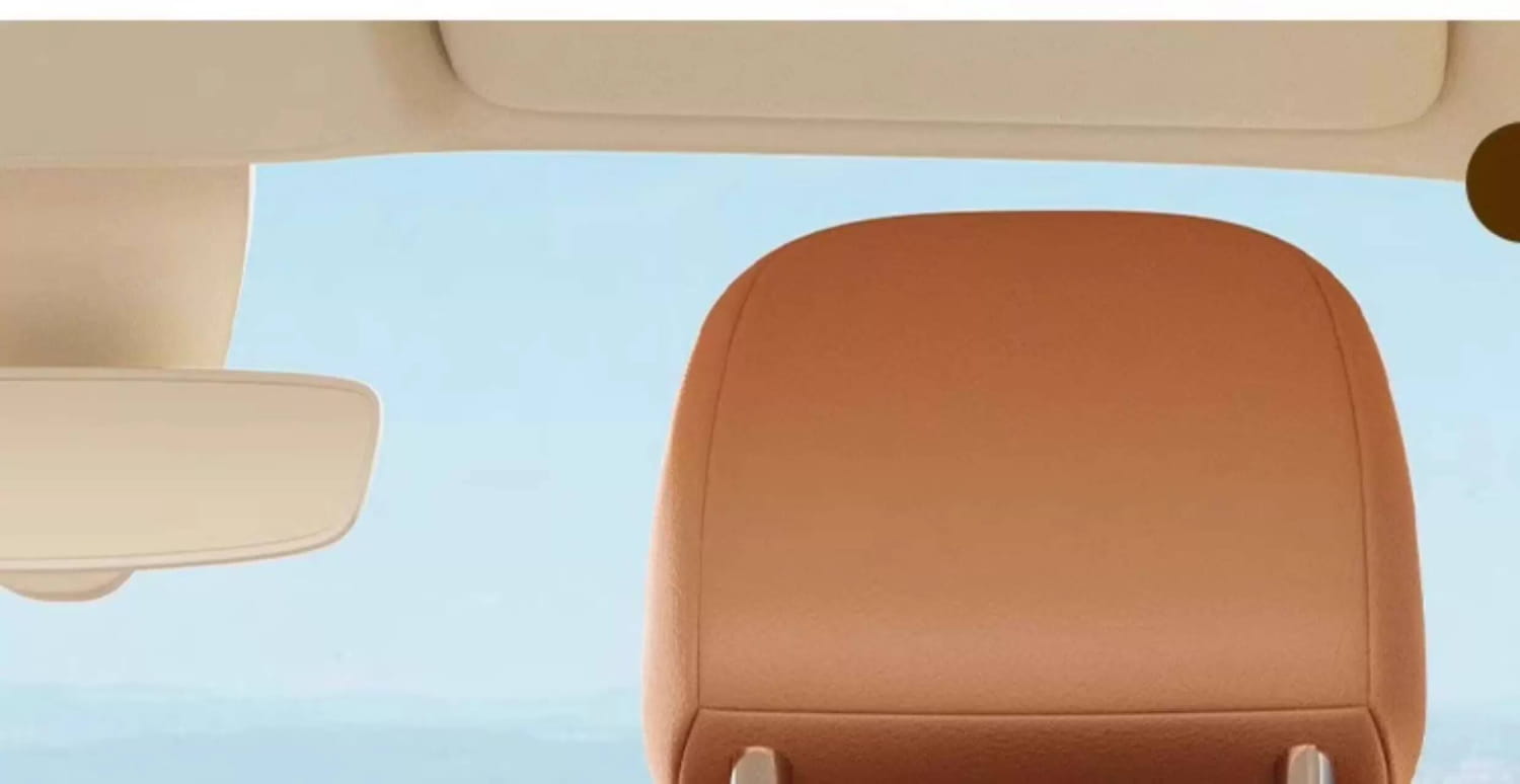 tan leather car headrest with attached car seat organizer animal alphabet storage pocket for convenient vehicle storage.