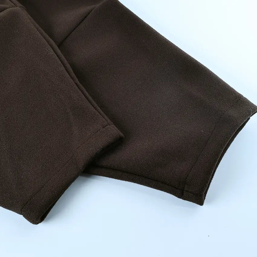 brown soft textured fabric pants with neatly stitched hems complement wool belted coat brown winter jacket for cold weather use