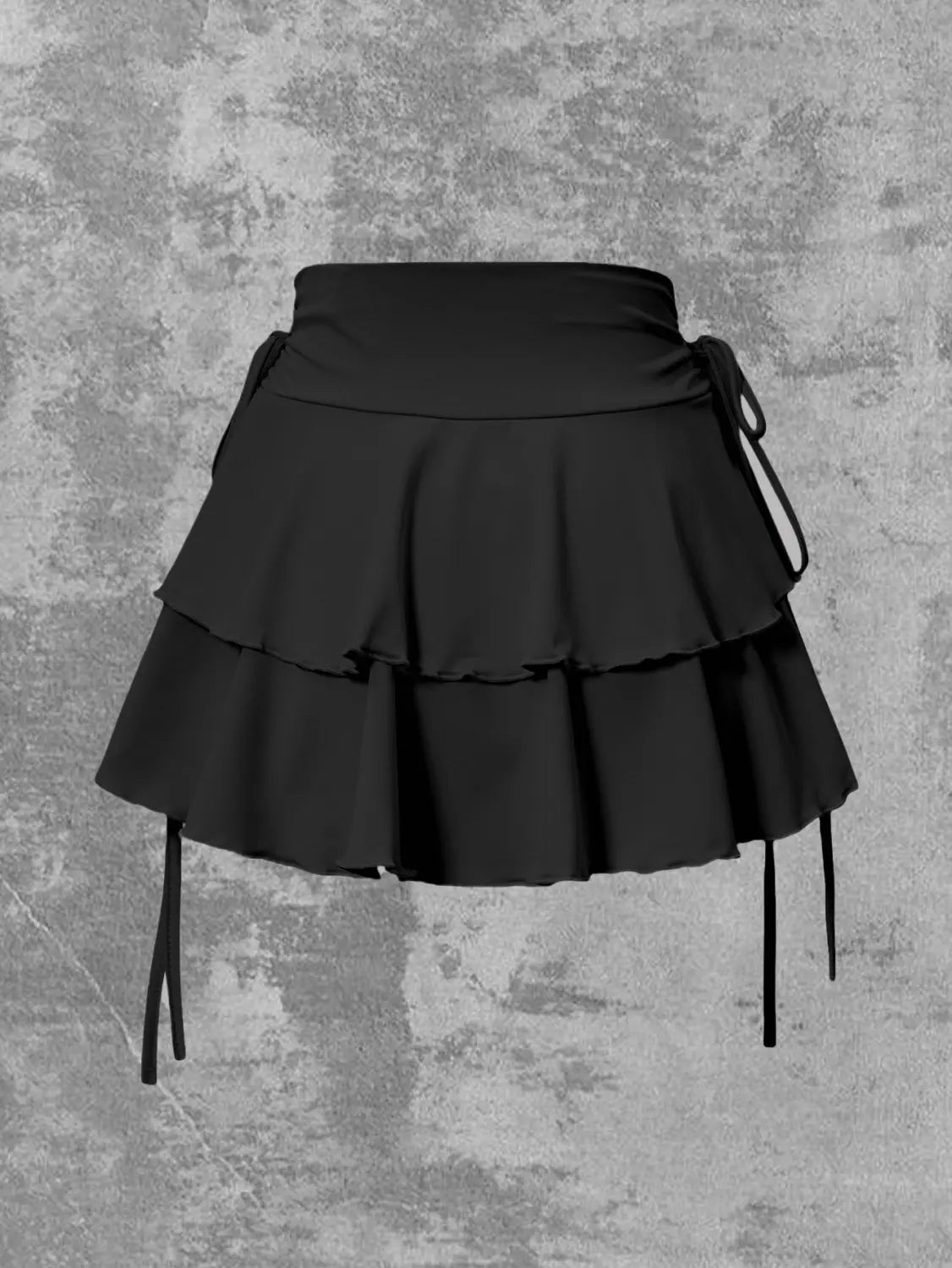 Black high waist ruffle mini skirt featuring tiered layers and side ties in black fabric.