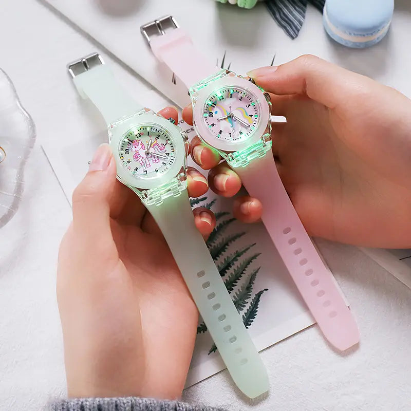 Kids unicorn led light up silicone digital watches with pastel green and pink unicorn-themed led lights and translucent silicone straps.