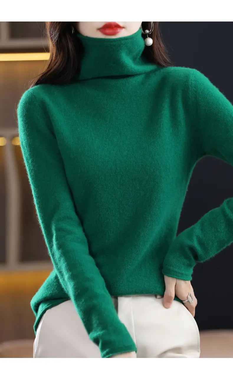 A rich emerald green merino wool turtleneck sweater for women with long sleeves and a soft plush texture.