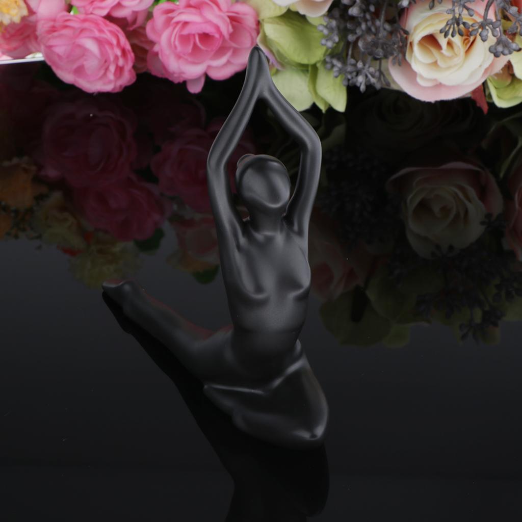 black ceramic figurine of a woman in a graceful yoga pose from the glossy resin yoga figurine set