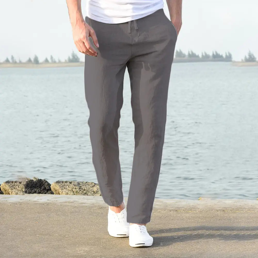 Gray linen chino pants with a drawstring waistband made of breathable cotton linen for casual wear.
