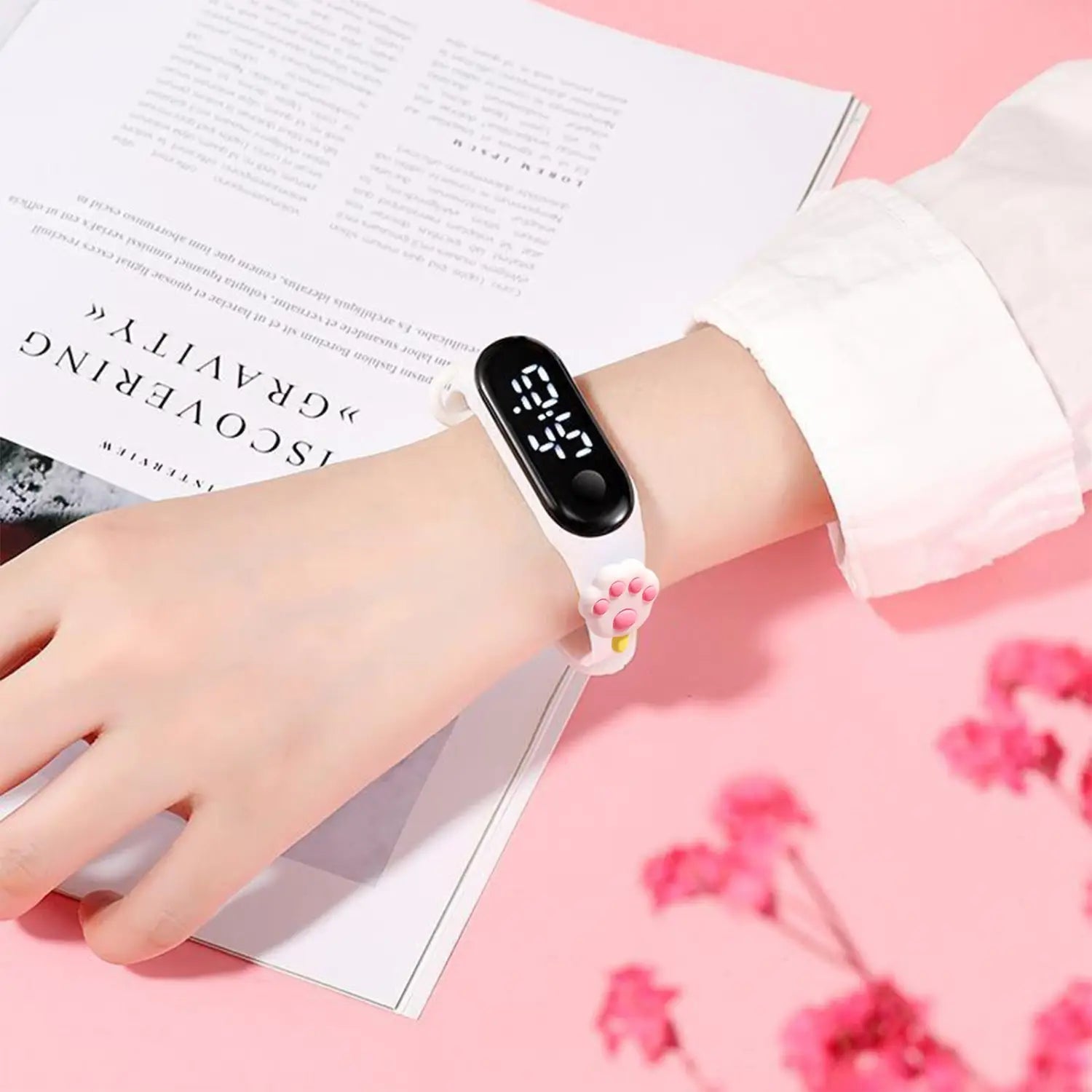 White kids silicone digital watch with a life waterproof feature featuring a black rectangular display and a cute paw print design on the strap.