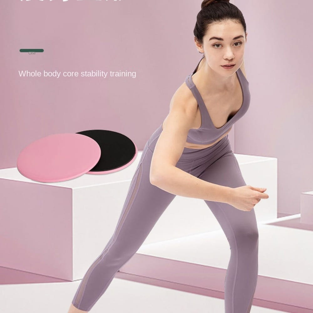 Pink and black circular core sliders fitness gliding discs for abdominal training made of durable stability material for whole body core exercises.