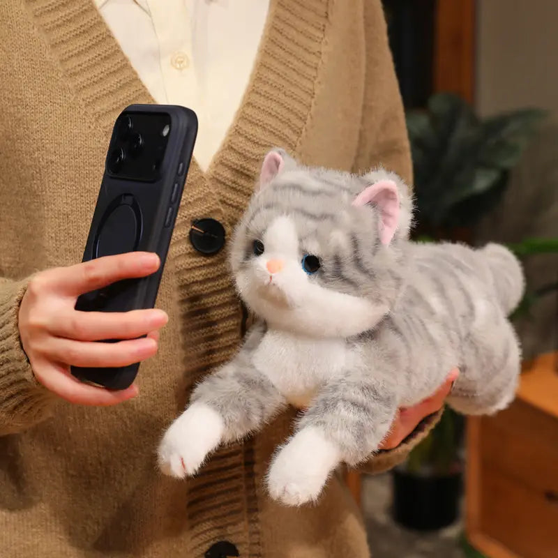 a soft gray and white plush kitten stuffed animal pillow with black eyes pink inner ears and a tiny orange nose designed as a cuddly plush toy