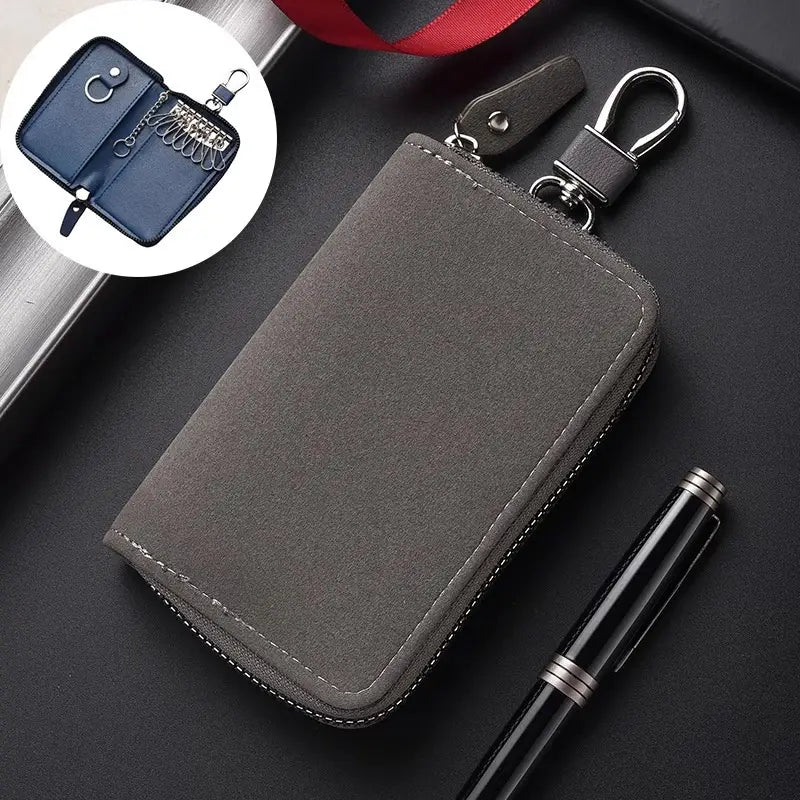 Gray suede leather key holder organizer pouch with silver-toned zipper and metal carabiner clip.