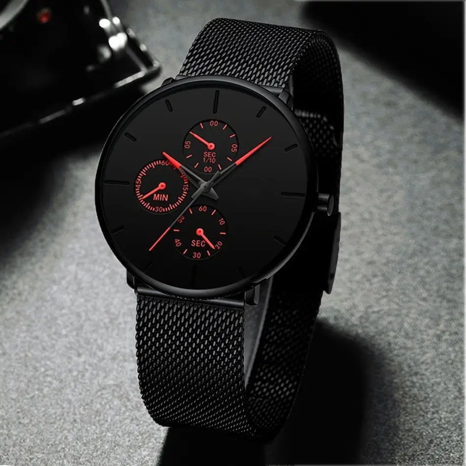 Montre à quartz à maille noire ultrafine pour hommes, avec un cadran noir élégant, des aiguilles rouge vif et trois sous-cadrans chronographe.