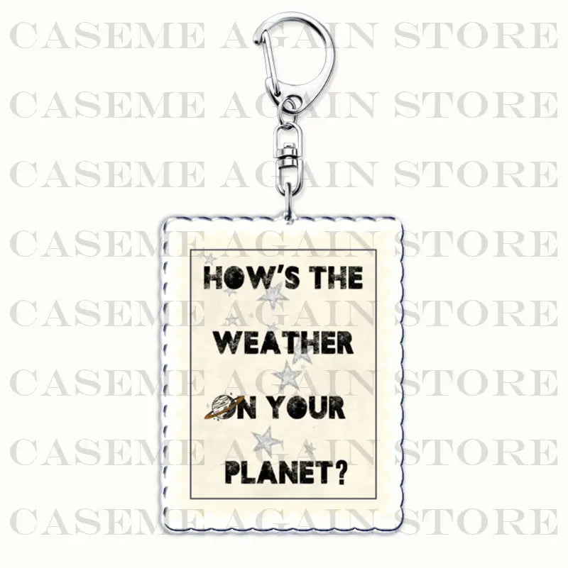 White rectangular acrylic keychain with black text hows the weather on your planet and small star and planet illustrations attached to a silver metal clasp from the Gracie Abrams acrylic keychain anime fan gift collection.