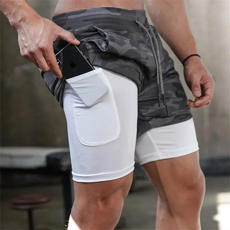 men 2 in 1 gym shorts featuring a gray and white camouflage outer layer with quick dry fabric designed for workout and activewear.