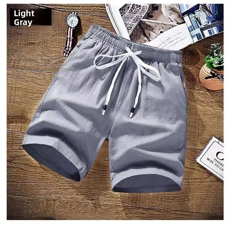 Herren-Leinen-Boxer-Slips aus hellgrauer Baumwolle mit Kordelzugbund und dunkelgrauem Besatz am Saum, entworfen für lässige, lockere Sommer-Strandbekleidung.