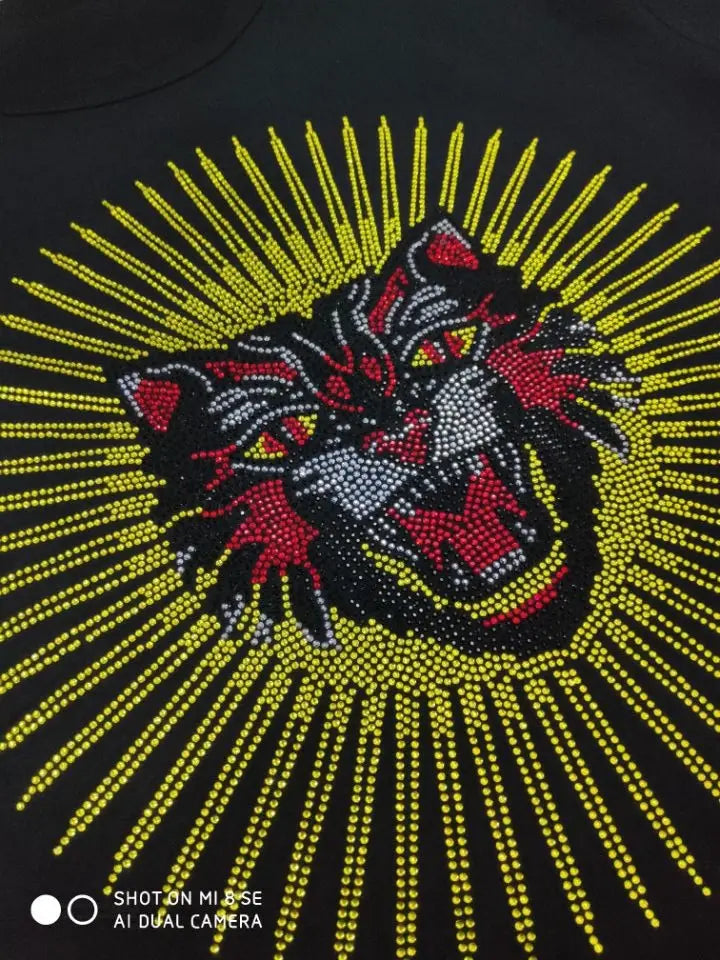 Black men rhinestone devil bear graphic tee featuring a vibrant tiger head embellished with red and silver rhinestones and yellow sunburst rays.