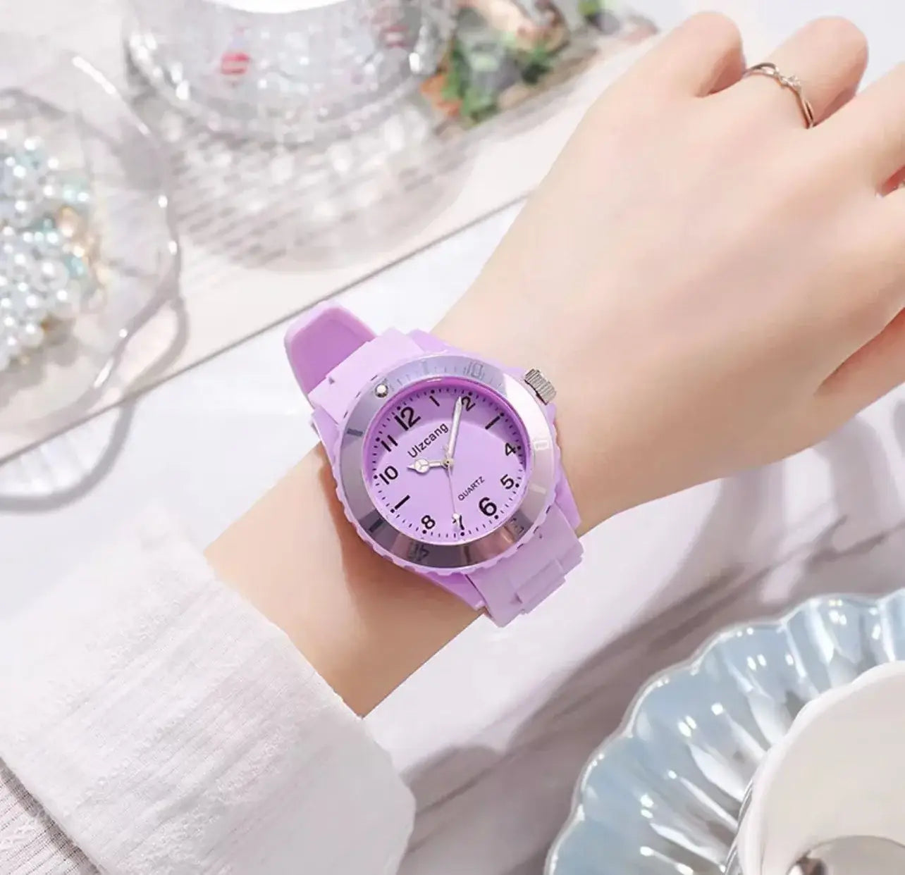 A kids silicone quartz watch with a colorful lavender silicone strap and a silver-toned bezel and face featuring the brand name Ultracool on its dial.