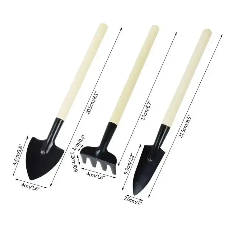 Set of three black metal small gardening tools with cream-colored wood handles including a garden shovel.