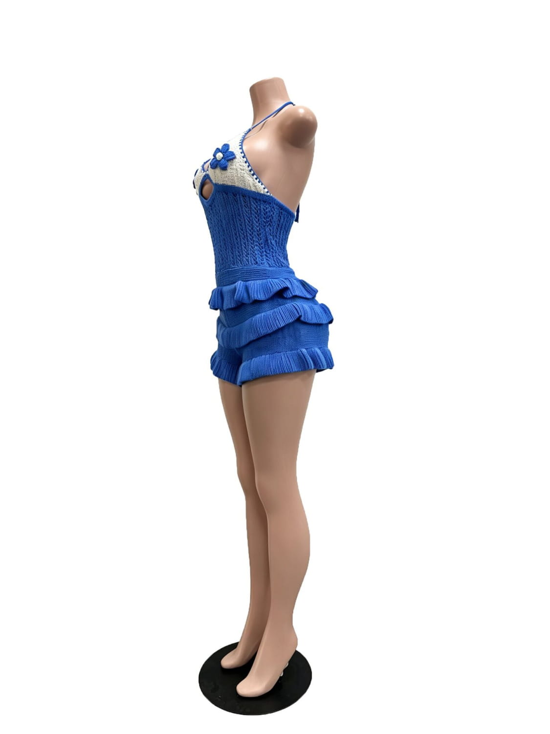 Blue knitted ruffle halter romper summer playsuit featuring a halter neckline, ruffled shorts, and a floral embellishment on the shoulder.