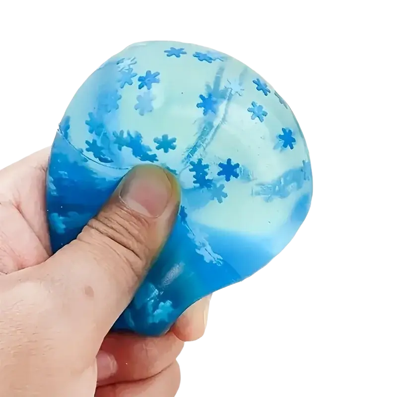 A front view of a translucent blue snowflake ice cube stress relief toy with embedded star-shaped glitter