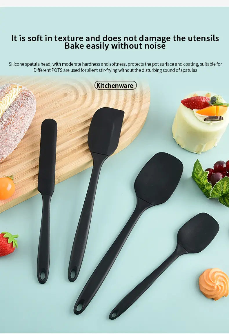 Set of four black silicone kitchenware spatulas with smooth non-slip handles and rounded heads designed for gentle cooking and baking.