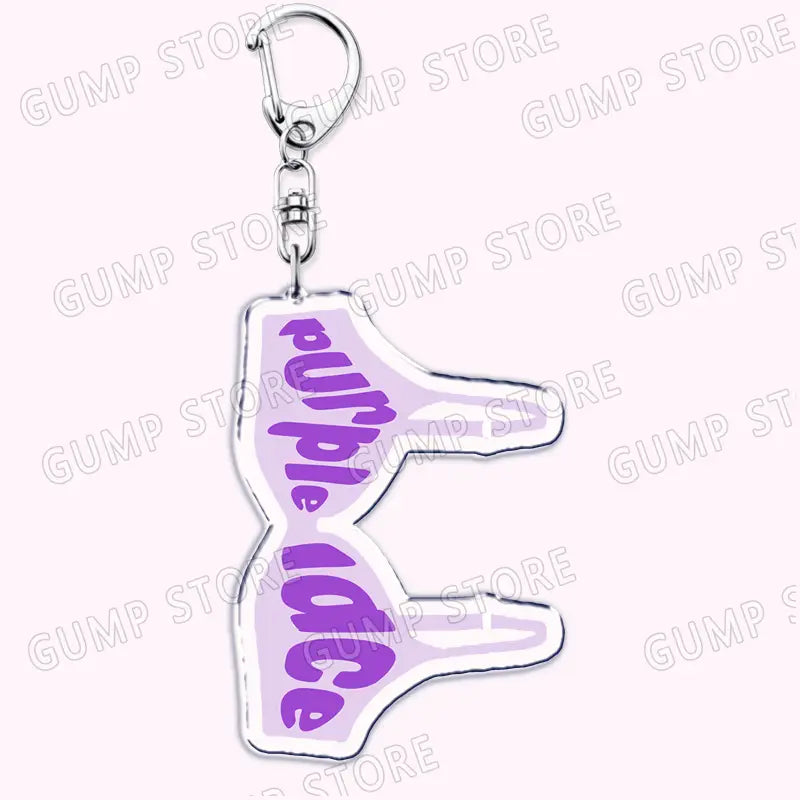 Purple acrylic Tate Mcrae keychain shaped like a thumbs up with purple ice printed in purple script for music fan gift.