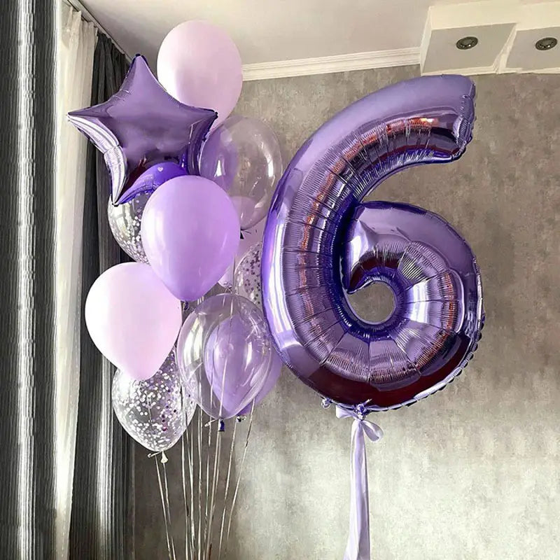 A shiny metallic purple 32 inch number six birthday party balloon made of foil with a satin ribbon tied to its base.