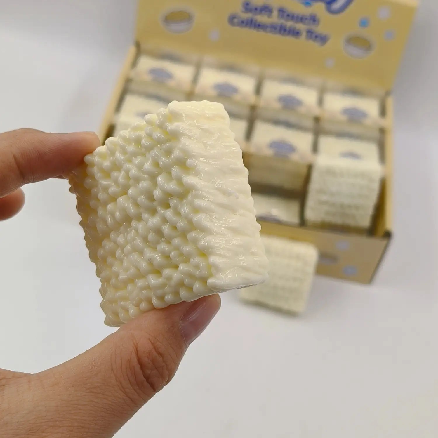 a creamy white textured collectible soap bar with a bumpy bead-like surface designed as an instant noodle squishy toy for stress relief and building block play