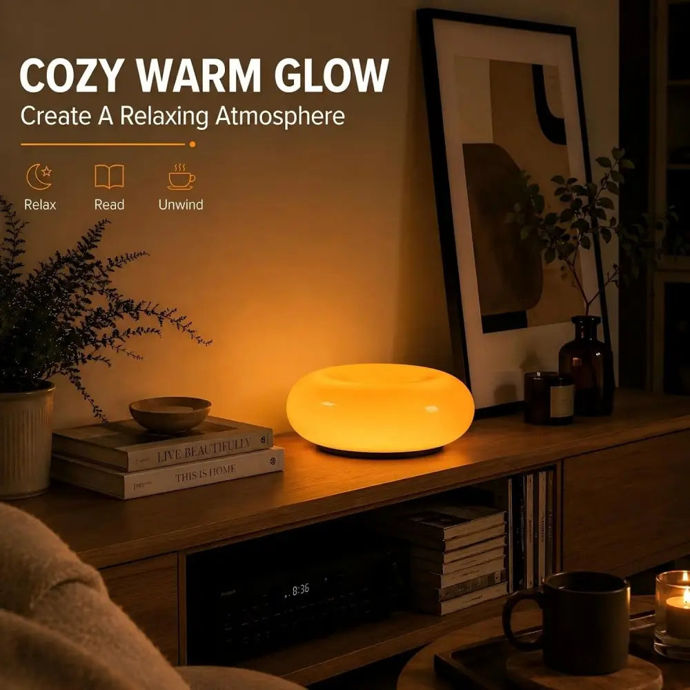 Un élégant luminaire mural tactile ovale en acrylique orange, à luminosité réglable, diffusant une lueur chaude jaune à LED dans un design minimaliste