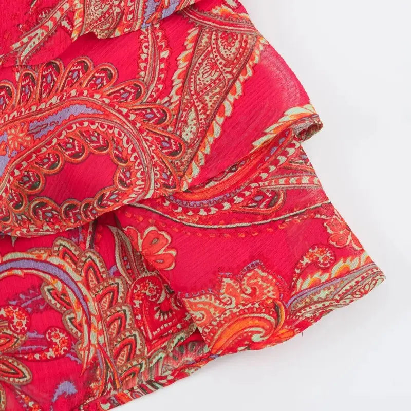 a vibrant red paisley halter top and midi skirt set featuring a lightweight scarf with intricate orange purple and beige designs