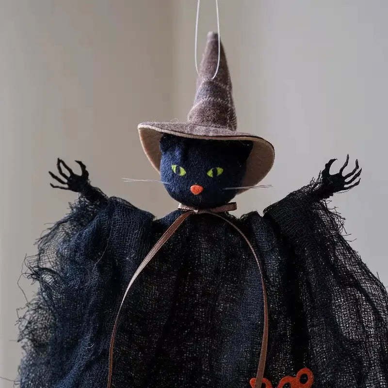 Colgante de adorno de halloween de gato bruja de fieltro negro con ojos verdes luminosos, nariz naranja y sombrero puntiagudo marrón, figura colgante de tela.