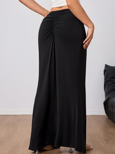 Black high waisted slit maxi skirt featuring a flowing ruched design for an elegant look.