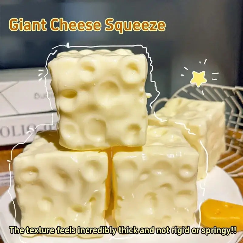 Cream-colored cube-shaped cheese squishy toy with textured surface resembling swiss cheese holes shown from a front angle for stress relief.