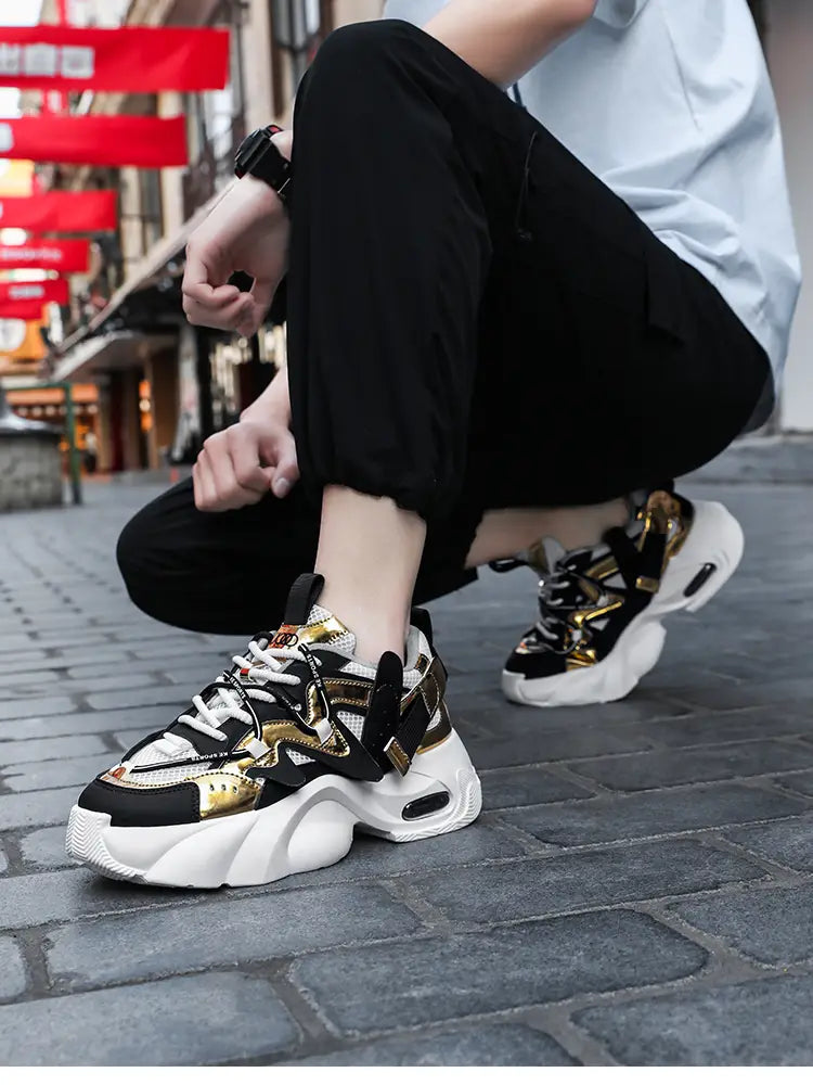 Men chunky air cushion casual sneakers in black and gold featuring a bold layered design with white soles and chunky platform style.