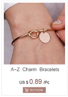 A delicate rose gold-toned charm bracelet with a sleek interlocking loop design and a small round disc pendant complementing the Gold Angel Number 7 Necklace.