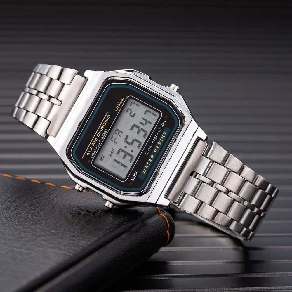 Silver digital stainless steel women watch with a rectangular face, metallic link bracelet, and black display screen showing time.