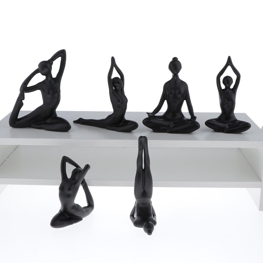 Set of six glossy black resin yoga pose figurines ideal for decorative display or yoga enthusiasts.