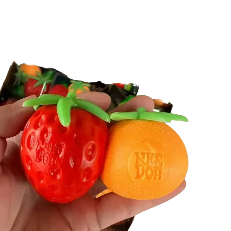 A vibrant red and orange 3pcs squishy toy set shaped like strawberry and orange with green stems front view