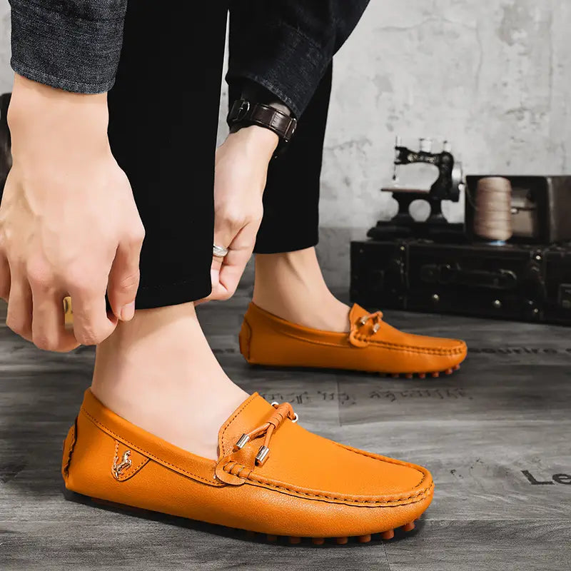 Chaussures à enfiler habillées en cuir orange pour hommes, se portant sans effort avec des chaussures décontractées, avec un nœud décoratif et des accents métalliques.