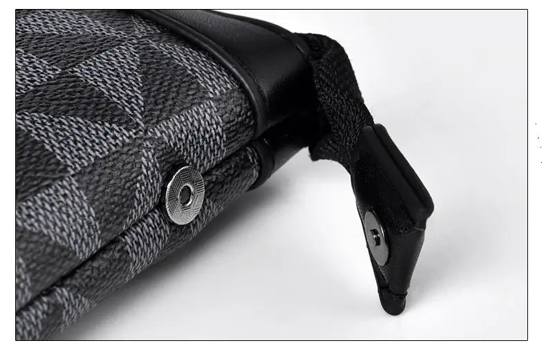 men clutch bag made of pu leather with black and gray geometric pattern fabric, black leather trim, silver-toned snap button closure, adjustable strap, and pocket interior for organizing essentials.