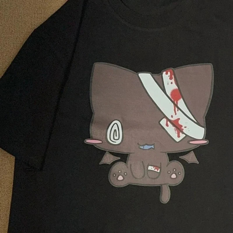 Black t-shirt featuring a cartoonish brown cat with bandages and blood splatters on its head printed on the front in a cartoon nurse print Y2K Harajuku style.