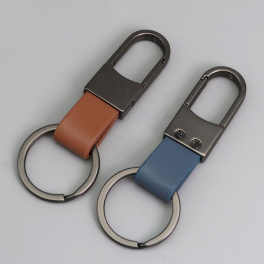 Two sleek leather keychain carabiners with anti lost waist rings featuring metallic clips and circular rings in tan and blue leather.