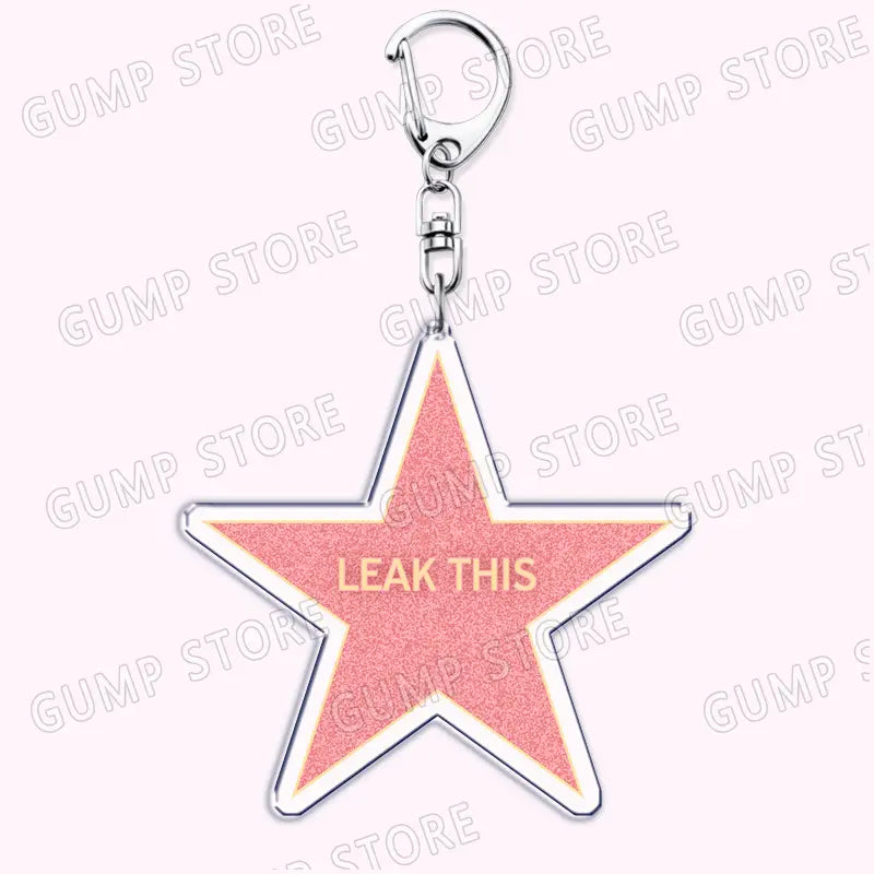 A pink star-shaped acrylic keychain with a silver metallic outline and clasp featuring gold lettering leak this for Tate Mcrae music fan gift.