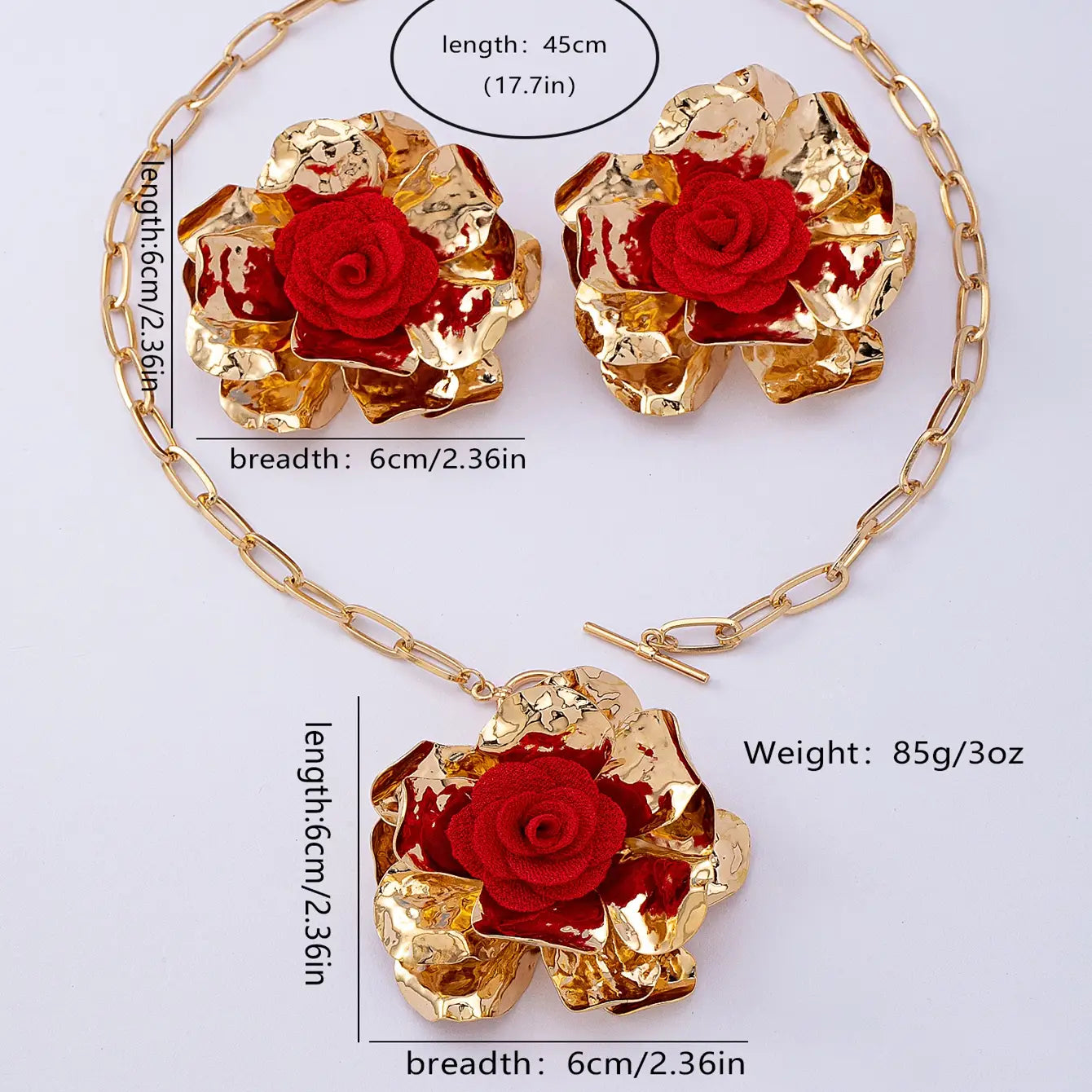 Gold-toned chain necklace with a central textured metallic rose pendant and matching earrings featuring vibrant red fabric roses in the red floral jewelry set gold rose necklace and earrings.