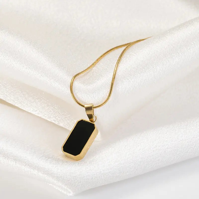 Collier médaillon rectangle en or pour femmes, avec un pendentif type plaque d’identité ton or et un insert en émail noir élégant, sur une chaîne serpent dorée assortie