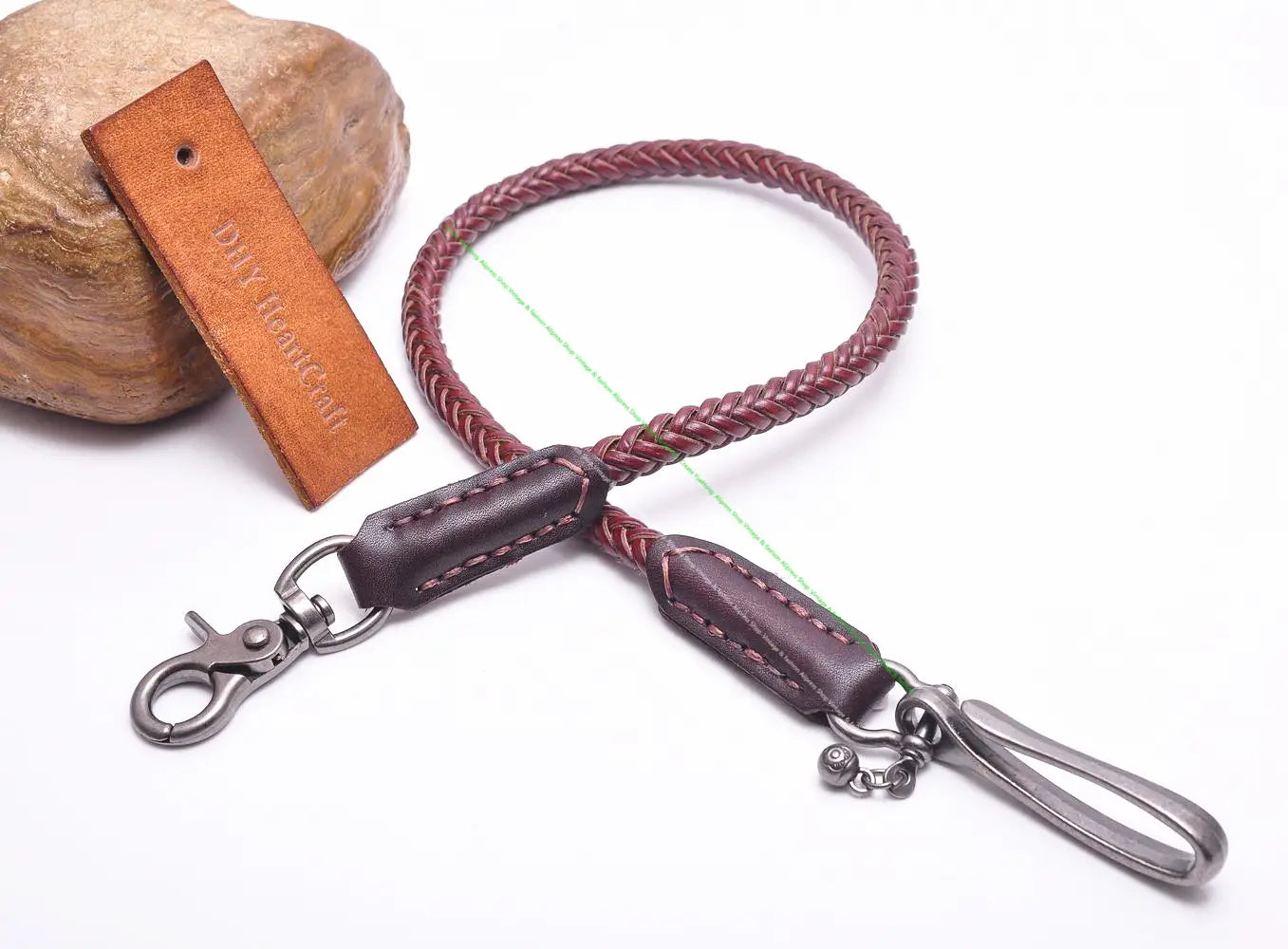 A braided burgundy leather biker wallet chain lanyard with dark brown stitched ends and silver toned metal clasps designed as a punk jeans accessory.