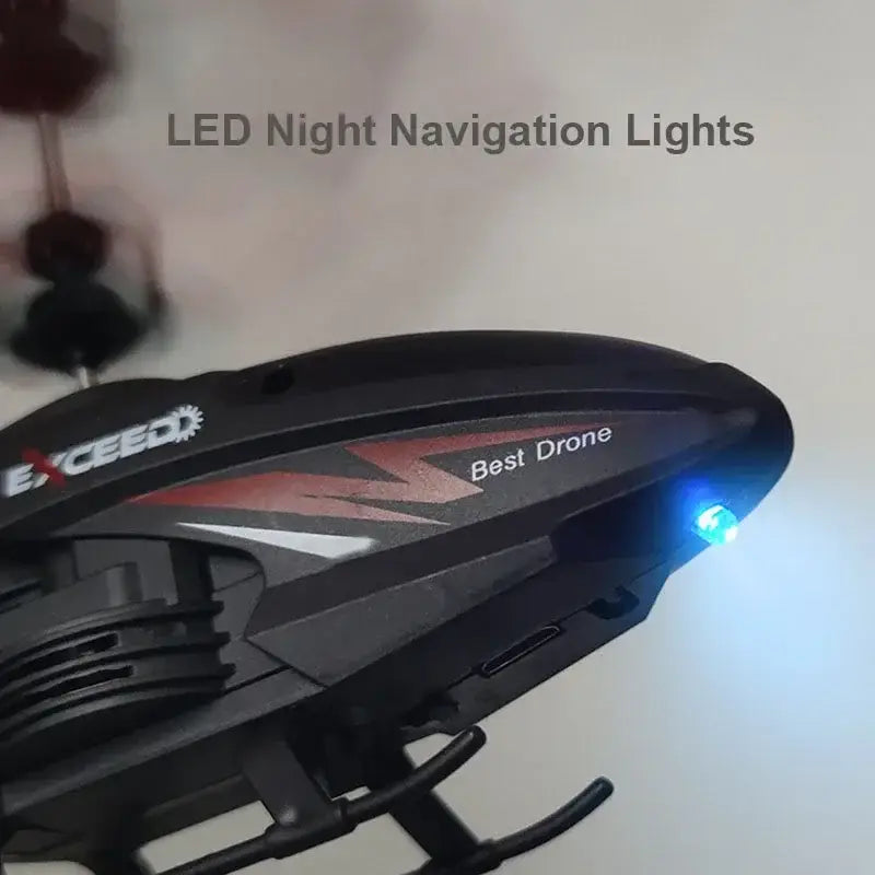 Black plastic exceed remote control induction helicopter led drone with red and white graphics labeled best drone and featuring a glowing blue led night navigation light ideal for extended flight time and efficient charging time.