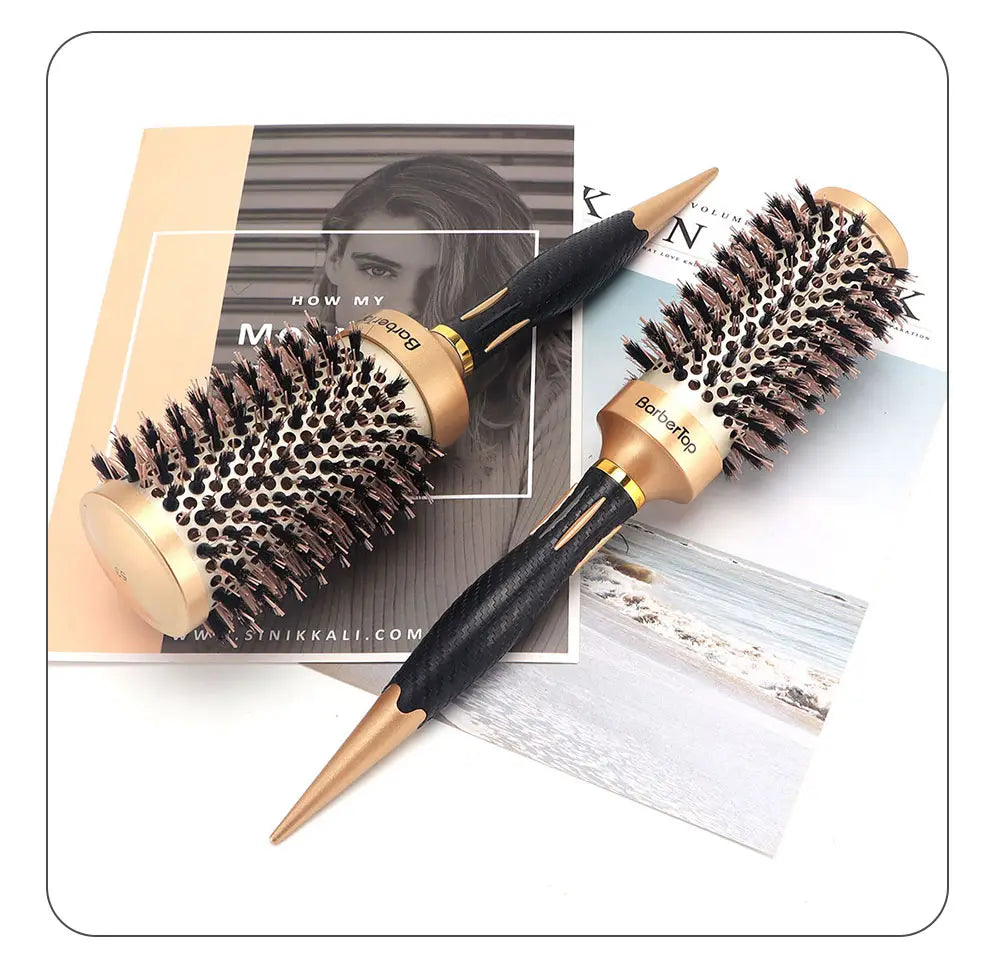 Two Barberroo aluminum round hair styling brushes with black and gold handles and dense dark bristles on a rounded barrel design.