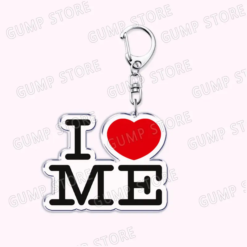 Silver acrylic keychain featuring bold black i me text with a vibrant red heart symbolizing love for Tate Mcrae music fan gift on a white background.