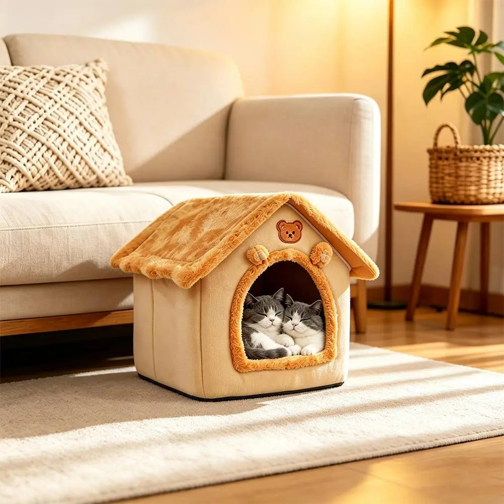 A cozy beige and warm orange plush pet bed 33x32x30cm cat cave with a fuzzy roof, bear face emblem, and soft interior where two gray and white cats are resting.
