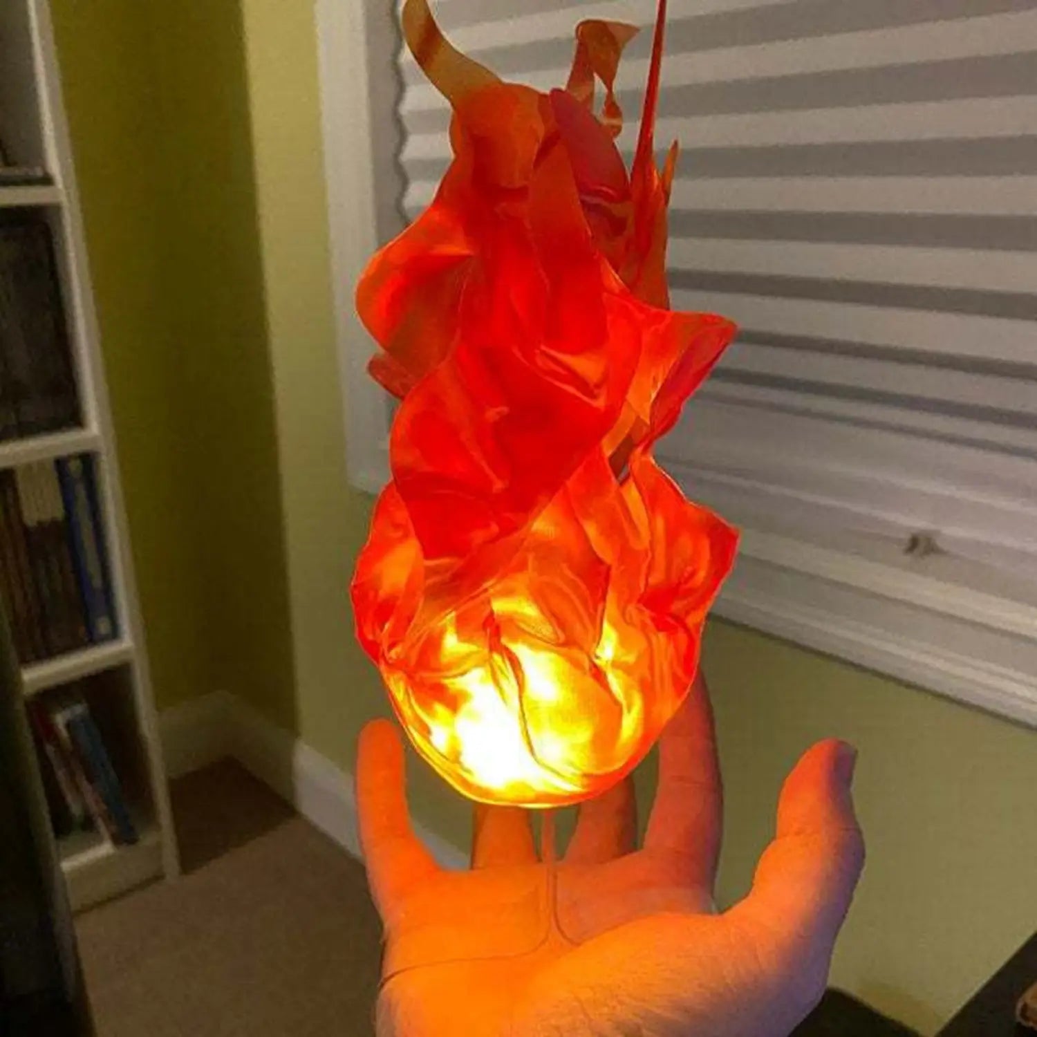 A glowing orange and red flame-shaped LED lamp with a translucent sculpted design featured as a floating fireball LED Halloween prop.