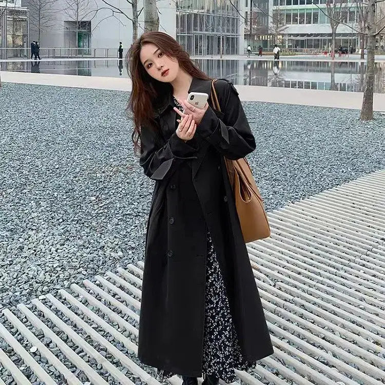 black long women double-breasted trench coat with classic design and subtle lapel detailing for casual windbreaker use